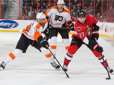 Curtis Lazar #27 of the Ottawa Senators stickhandles the puck against Pierre-Edouard Bellemare #78 of the Philadelphia Flyers.