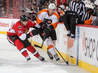 Alex Chiasson #90 of the Ottawa Senators battles for puck possession against Michael Raffl #12 of the Philadelphia Flyers.