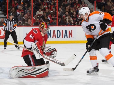 Craig Anderson #41 of the Ottawa Senators makes a save as Matt Read #24 of the Philadelphia Flyers looks for a rebound.