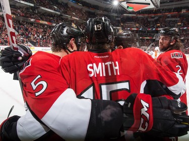 Zack Smith #15 of the Ottawa Senators celebrates his first period goal against the Philadelphia Flyers with teammates Cody Ceci #5 and Jared Cowen #2.