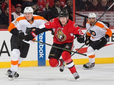 Curtis Lazar #27 of the Ottawa Senators is held up on the forecheck by Evgeny Medvedev #82 of the Philadelphia Flyers.