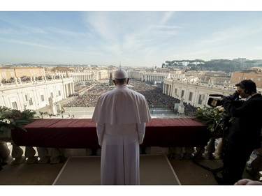 Pope Francis delivers his "Urbi et Orbi" (to the city and to the world) blessing from the central balcony of St. Peter's Basilica at the Vatican, Friday, Dec. 25, 2015. Pope Francis is praying that recent U.N.-backed peace agreements for Syria and Libya will quickly end the suffering of their people while praising the generosity of those countries that have taken their refugees in.
