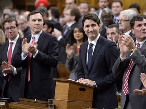 Prime Minister Justin Trudeau receives applause from Liberals after speaking in the House of Commons Monday.