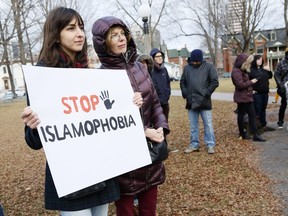Protestors hold signs at a protest against Islamophobia at Dundonald Park in Ottawa on Sunday, December 13, 2015.  (Patrick Doyle / Ottawa Citizen)  ORG XMIT: 1213 Islamophobia07