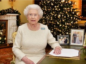 Queen Elizabeth II sits at a desk in the 18th Century Room at Buckingham Palace, after recording her Christmas Day broadcast to the Commonwealth on December 25, 2015 in London, England.