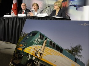 The train damaged in the 2013 collision between a Via Rail train and OC Transpo bus is seen as Transportation Safety Board Investigator-in-charge Rob Johnston, left,, TSB chair Kathy Fox and board member Hélène Gosselin speak to media after releasing the final report.