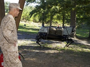 U.S. Marine Corps Gen. James F. Amos, the commandant of the Marine Corps, watches a demonstration of a legged squad support system (LS3) by the Defense Advanced Research Project Agency at Joint Base Myer-Henderson Hall, Va., Sept. 10, 2012. The LS3 was being developed for use by the military to carry loads and equipment over a variety of terrains. (U.S. Marine Corps photo by Sgt. Mallory S. VanderSchans/Released)
