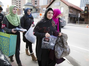 Sana Nooraldeen, centre,  and a group of students forming a chapter of Who is Hussain gathered to hand out packages to people in need outside the Ottawa Mission and surrounding area. The packages contained a winter hat, mittens, and a pair of thick socks.