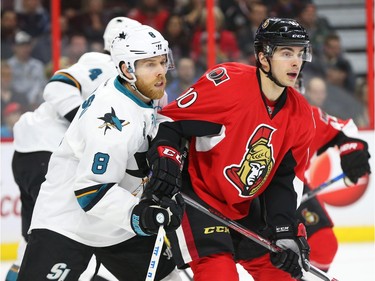 Shane Prince of the Ottawa Senators battles against Joe Pavelski of the San Jose Sharks first period NHL action.