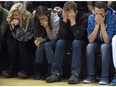 Shyanne Bryant, from left, Makayla Bryant, Keaton Dontanville and Caiden Dontanville attend a vigil held on the University of Colorado-Colorado Springs' campus for those killed in Friday's deadly shooting at a Planned Parenthood clinic Saturday, Nov. 28, 2015, in Colorado Springs, Colo.