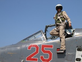 A Russian army pilot is seen leaving the cockpit of a Russian Sukhoi Su-25 ground attack aircraft at the Hmeimim airbase in the Syrian province of Latakia.