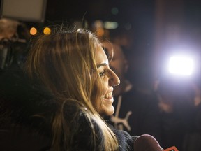 Syrian Christine Youssef speaks to reporters outside a hotel as she waits to meet cousins who are due to arrive with other Syrian refugees on the first government-arranged flight into Toronto's Pearson Airport, on Friday, Dec. 11, 2015.