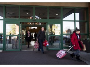 Syrian refugees leave the hotel alongside their sponsors, in Toronto, on Friday, Dec. 11, 2015.