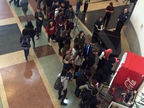 Students from Lisgar Collegiate wait for their chance to hug a Coca-Cola machine at Ottawa City Hall in exchange for a free Coke.