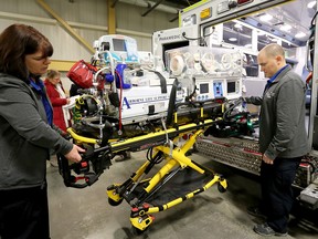 The neonatal team demonstrate the new isolette power lift at Ottawa Paramedic Service headquarters.
