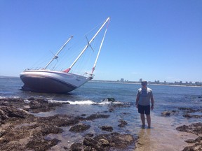 Northern Magic, the 42-foot boat on which Ottawa's Stuemer family circumnavigated the globe from 1997-2001, lies on the rocks on a beach in Uruguay.