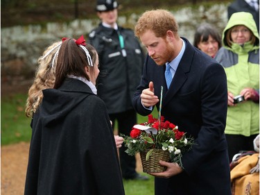 Prince Harry meets members of the public as he attends a Christmas Day church service at Sandringham on December 25, 2015 in King's Lynn, England.