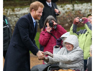 Prince Harry meets members of the public as he attends a Christmas Day church service at Sandringham on December 25, 2015 in King's Lynn, England.