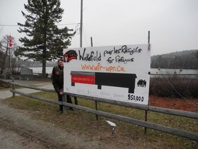 The Wakefield for Refugees group is raising money to sponsor two Syrian refugee families. They erected a fundraising sign on the main street of the small Quebec town north of Ottawa.