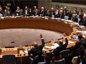 Foreign Ministers vote during a UN Security Council meeting on Syria at the United Nations in New York on December 18, 2015. The UN Security Council on Friday unanimously adopted a resolution endorsing a peace process to end the nearly five-year war in Syria.