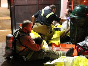 A firefighter holds one of the twin toddlers rescued from a Caldwell Avenue apartment fire Saturday, Dec. 5, 2015.