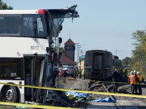 An OC Transpo bus sits where it collided with a Via Rail train during the morning commute. (THE CANADIAN PRESS/Adrian Wyld)
