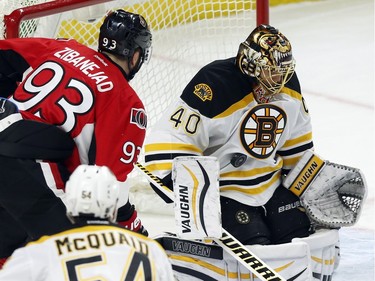 Boston Bruins goaltender Tuukka Rask (40) blocks the puck as Ottawa Senators' Mika Zibanejad (93) looks on during first period NHL hockey action in Ottawa on Sunday, December 27, 2015.