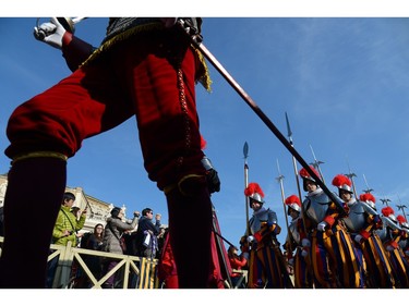 Swiss guards parade before the arrival of Pope Francis for the traditional "Urbi et Orbi" Christmas message to the city and the world, on December 25, 2015 at St Peter's square in Vatican. Pope Francis was expected to appeal for reconciliation of fractured communities in his Christmas Day blessing Friday, as the world takes stock of a year of violence and suffering that saw hundreds of thousands flee their homes.