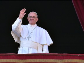Pope Francis waves from the balcony of St Peter's basilica during the traditional "Urbi et Orbi" Christmas message to the city and the world, on December 25, 2015 at St Peter's square in Vatican. Pope Francis was expected to appeal for reconciliation of fractured communities in his Christmas Day blessing Friday, as the world takes stock of a year of violence and suffering that saw hundreds of thousands flee their homes.