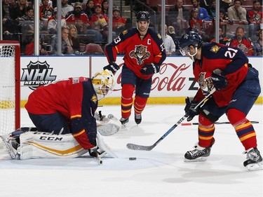 Florida Panthers forward Vincent Trocheck (21) clears the puck from in front of goalie Roberto Luongo (1) during the second period.