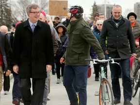 Mayor Jim Watson (centre left), city councillors Maithieu Fleury (centre right) and Tobi Nussbaum, second from right) and hundreds of happy local residents were on hand Friday (Dec 4, 2015) for the official opening of the new pedestrian bridge over the Rideau River.  Given the Algonquin name, Adawe, which means "to trade," the bridge now links Somerset Street in Sandy Hill with Donald Street in New Edinburgh. (Julie Oliver / Ottawa Citizen)