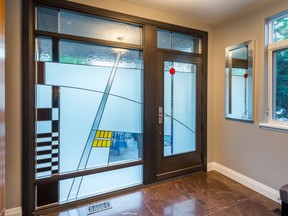 A sweeping stained-glass window and door created by Jacques Hamel of Hamel Design for this custom home near the Rideau Canal is the highlight of the foyer.