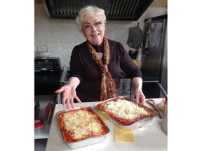 Nita Grassi shows off the lasagnas she made in the kitchen of Villa d'Abruzzo.