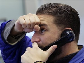 Trader Chris Dattolo watches prices on stock options at the New York Stock Exchange, Friday, Jan. 15, 2016. U.S. stocks plunged again on Friday, completing the worst two-week start to a year ever. (AP Photo/Mark Lennihan)