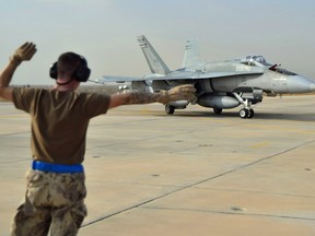 A Canadian Armed Forces CF-18 Fighter jet from 409 Squadron taxis after landing, in Kuwait in this file shot.