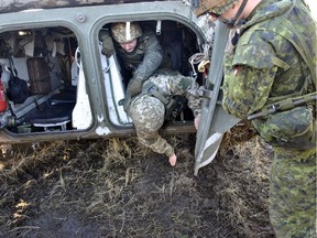 A Canadian soldier supervises Ukrainian soldiers as they conduct mine awareness drills during Operation UNIFIER at the International Peacekeeping and Security Centre (IPSC) in Starychi, Ukraine.