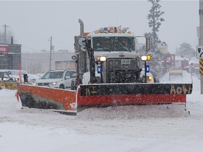 A city plow makes its way along Carling Avenue during the Dec. 29, 2015 snowstorm that dumped more than 20 cm on the city.