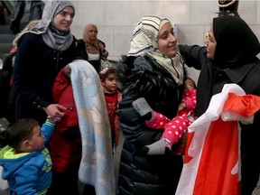 The first large group of government-sponsored Syrian refugees arrived in Ottawa  and were greeted by volunteers who showed up to welcome them at the airport.