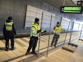 A temporary fence erected between domestic and international train tracks, at Hyllie train station in southern Malmo, Sweden, on Sunday Jan. 3, 2016, as authorities prepare to provide border control for migrants hoping to enter Sweden.  The Hyllie station is the first stop after crossing the Oresund Bridge from Denmark, and Swedish authorities will introduce identity checks for bus and train passengers entering Sweden, starting Monday Jan. 4, 2014.