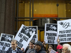 Activists hold signs containing the image of Turing Pharmaceuticals CEO Martin Shkreli in front the building that houses Turing's offices, in New York, Thursday, Oct. 1, 2015, during a protest highlighting pharmaceutical drug pricing.  Turing Pharmaceuticals sparked an angry backlash last month after it raised the price of Daraprim, the only approved treatment for a rare, life-threatening parasitic infection, by more than 5,000 percent.