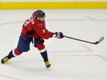 Washington Capitals left wing Alex Ovechkin (8) follows through as he scores his 500th career goal during the second period of a NHL hockey game against the Ottawa Senators in Washington, D.C., Sunday, Jan. 10, 2016.