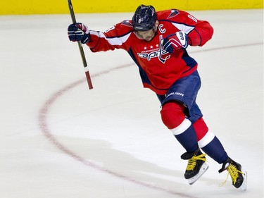 The Washington Capitals left wing Alex Ovechkin, (8), of Russia, leaps in the air in celebration after scoring his 500th career NHL goal during the second period of a hockey game against the Ottawa Senators in Washington, D.C., Sunday, Jan. 10, 2016.