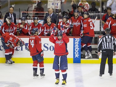 Washington Capitals left wing Alex Ovechkin (8), of Russia, acknowledges the fans in celebration as he comes back out of the box to a standing ovation after  Ovechkin scored his 500th career NHL goal during the second period of a hockey game against the Ottawa Senators in Washington, D.C., Sunday, Jan. 10, 2016.