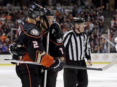 Anaheim Ducks center Andrew Cogliano (7) celebrates after scoring with defenseman Kevin Bieksa during the second period of an NHL hockey game against the Ottawa Senators in Anaheim, Calif., Wednesday, Jan. 13, 2016.