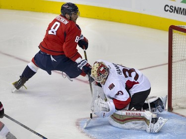 Ottawa Senators goalie Andrew Hammond (30) saves the puck from going in the goal on a play by Washington Capitals left wing Alex Ovechkin (8), of Russia, during the second period of a NHL hockey game in at the Verizon Center in Washington, Sunday, Jan. 10, 2016.