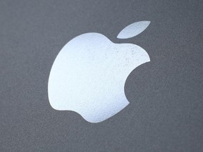 An Apple logo is seen on the back on a smartphone on August 6, 2014 in London, England.