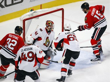 Chicago Blackhawks center Artem Anisimov (15) scores a goal past Ottawa Senators goalie Craig Anderson (41) during the third period of an NHL hockey game Sunday, Jan. 3, 2016, in Chicago. The Blackhawks won the game 3-0.