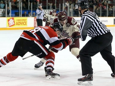 Ben Fanjoy #8 of the Ottawa 67's takes a face-off against Steven Lorentz #16 of the Peterborough Petes.