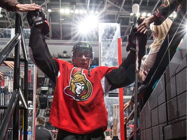 Shane Prince #10 of the Ottawa Senators high-fives fans as he leaves the ice after the warm up.