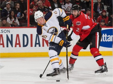 Jack Eichel #15 of the Buffalo Sabres fends off Jared Cowen #2 of the Ottawa Senators leading to his second period goal.